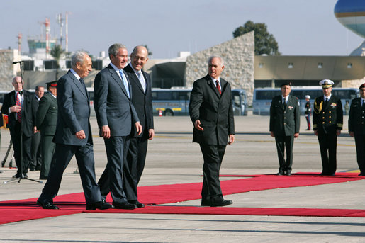 President George W. Bush is flanked by Israel’s President Shimon Peres, left, and Prime Minister Ehud Olmert as they arrive at Tel Aviv’s Ben Gurion International Airport Friday, Jan. 11, 2008, prior to the departure of Air Force One. White House photo by Chris Greenberg