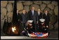 President George W. Bush bows his head as Marines lay a wreath on behalf of the United States of America, honoring the victims of the Holocaust, during a visit Friday, Jan. 11, 2008, to Yad Vashem, the Holocaust Museum in Jerusalem. White House photo by Eric Draper