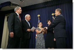 President George W. Bush watches as Vice President Dick Cheney swears in Jim Nussle as the Director of the Office of Management and Budget in the Dwight D. Eisenhower Executive Office Building Monday, Sept. 10, 2007. Pictured holding the bible is Director Nussle's daughter Sarah and his wife Karen Nussle. White House photo by Chris Greenberg