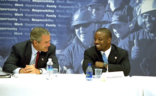 President George W. Bush talks with Patrick Patterson during a roundtable discussion on welfare reform in Charleston, S.C., Monday, July 29. "I believe that compassionate welfare reform must move forward, to strengthen work, to insist upon work as one of the benchmarks for success, because I believe work increases somebody's self worth and dignity," said President Bush of the reauthorization vote on the 1996 welfare reform bill. White House photo by Paul Morse.