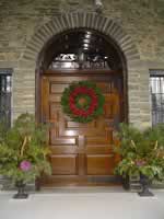 Photo of the front door at Grey Towers decorated with a wreath.