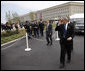 President George W. Bush salutes to military personnel as he arrives at the Pentagon Thursday, Sept. 11, 2008, for the dedication of the 9/11 Pentagon Memorial at the Pentagon in Arlington, Va. White House photo by Eric Draper