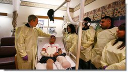 President George W. Bush speaks with U.S. Marine Cpl. Zachary Briseno of Fort Worth, Texas, at the National Naval Medical Center in Bethesda, Md., Wednesday, Dec. 19, 2007, after being awarded a Purple Heart medal and citation. Cpl. Briseno, joined by members of his family from left, Briseno's mother, Mariana; brothers, Roman and Tony; and Briseno's girlfriend, Jennifer Rangel, is recovering from injuries sustained in Operation Iraqi Freedom. White House photo by Joyce N. Boghosian