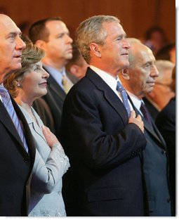 President George W. Bush and Laura Bush are seen with Israeli leaders Prime Minister Ehud Olmert, left, and Israeli President Shimon Peres during the playing of the National Anthem Wednesday, May 14, 2008 in Jerusalem, during a celebration of Israel's 60th anniversary as a nation at the Israeli Presidential Conference 2008 at the Jerusalem International Convention Center. White House photo by Shealah Craighead