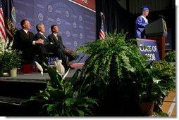 President George W. Bush shares a smile with Superintendent of Greensburg Schools, Darin Headrick, (left), and Greensburg High School Principal Randy Fulton, as Senior Class President Jarrett Schaef gives the Salutorian address during commencement ceremonies for the Greensburg High School Class of 2008. The town of Greensburg, KS was almost entirely destroyed when a tornado tore through the town one year ago today. White House photo by Chris Greenberg