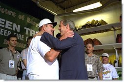President George W. Bush embraces rescued coal miner John Unger at the Green Tree Fire Department in Green Tree, Pa., Monday, Aug. 5. Pulled from a collapsed mine in Somerset, Pa., nine miners survived three days in a flooded mine shaft before rescuers found them. Also pictured are, from left to right, miners Mark Popernack, Randy Fogle and Tom Foy. "Today we're here to celebrate life, the value of life, and as importantly, the spirit of America," said the President in his remarks. "I asked to come by to meet our nine citizens and their families because I believe that what took place here in Pennsylvania really represents the best of our country, what I call the spirit of America, the great strength of our nation." White House photo by Paul Morse.