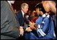 President George W. Bush greets students after remarks at Parkview Arts and Science Magnet High School in Little Rock, Arkansas, Thursday, Aug. 29. 