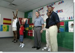 President George W. Bush watches an exercise class during a tour of Lakewest Family YMCA in Dallas, Texas, Friday, July 18, 2003. Also pictured, at far right, are Lynn Swann, Chairman of the President's Council on Physical Fitness and Sports and YMCA Volunteer Andrews Simpson.  White House photo by Paul Morse