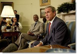 President George W. Bush and United Nations Secretary General Kofi Annan talk with the media during a meeting in the Oval Office Monday, July 14, 2003. They discussed President Bush's recent trip to Africa, and issues concerning Liberia and Iraq.  White House photo by Paul Morse