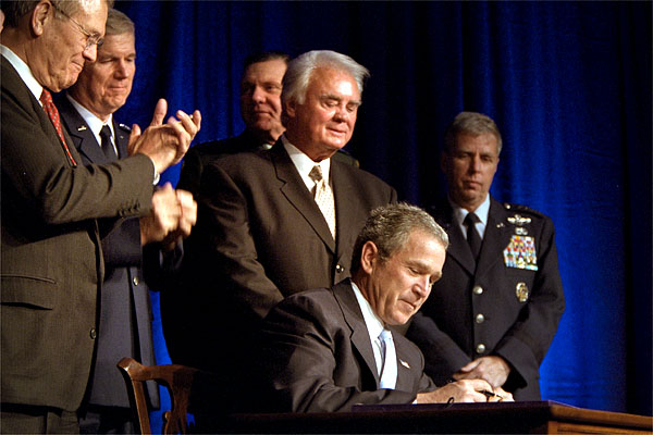 President George W. Bush signs a defense appropriations bill at the Pentagon, Jan., 10. Photographed with President Bush are Secretary of Defense Donald Rumsfeld (far left), Chairman of the Joint Chiefs of Staff General Richard Myers (center, left), House Armed Services Committee Chairman Rep. Bill Young (directly behind President Bush), Army Vice Chief of Staff Gen. John Keane (behind Mr. Young) and Air Force Vice Chief of Staff General Robert H. Foglesong (far right). White House photo by Paul Morse.