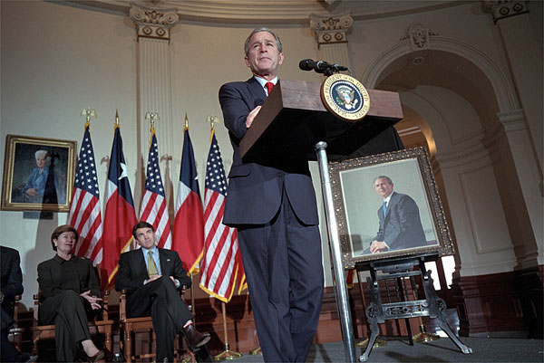 As Mrs. Bush and Texas Governor Rick Perry listen, President George W. Bush speaks during the ceremony for the unveiling of his portrait painted by Scott Gentling at the Texas State Capitol in Austin Jan. 4, 2001. White House photo by Eric Draper.