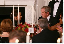 President George W. Bush shares a toast with Alma Powell, left, wife of former Secretary of State Colin Powell, Tuesday evening, Nov. 13, 2007 in the State Dining Room of White House, during a social dinner in honor of America's Promise-The Alliance for Youth. White House photo by Joyce N. Boghosian