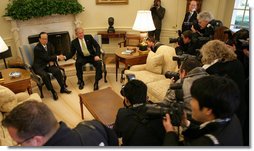President George W. Bush and Prime Minister Yasuo Fukuda pause for White House press photographers Friday, Nov. 16, 2007, during their meeting in the Oval Office.  White House photo by Eric Draper