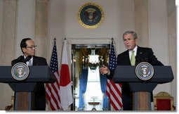 As Prime Minister Yasuo Fukuda of Japan looks on, President George W. Bush makes remarks during a joint statement Friday, Nov. 16, 2007, in the Cross Hall of the White House. Said the President, "The alliance between our two countries is rooted deeply in our strong commitments to freedom and democracy." White House photo by Chris Greenberg