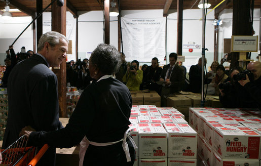 President George W. Bush talks with 85-year-old Doris Lewis Monday, Nov. 19, 2007, during a stop at the Central Virginia Community Food Bank in Richmond, Va. "You have a sweet heart," the President told the volunteer, who was celebrating her birthday at the warehouse. White House photo by Chris Greenberg