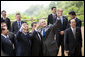 President George W. Bush joins President Nicolas Sarkozy of France, and Jose Manuel Barroso, President of the European Union, as they wave to hotel staff Tuesday, July 8, 2008, following the G-8 family portrait at the Windsor Hotel Toya Resort and Spa. Looking on are Italy's Prime Minister Silvio Berlusconi, lower left, President Dmitriy Medvedev of Russia, left, and Prime Minister Yasuo Fukuda of Japan, right, host of the 2008 Summit. White House photo by Eric Draper