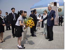 President George W. Bush and Laura Bush are welcomed on their arrival Sunday, July 6, 2008 to the New Chitose International Airport, to attend the Group of Eight Summit in Toyako, Japan.  White House photo by Eric Draper