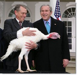 President George W. Bush is joined by Lynn Nutt of Springfield, Mo., as he poses with “Flyer” the turkey during a ceremony Wednesday, Nov. 22, 2006 in the White House Rose Garden, following the President’s pardoning of the turkey before the Thanksgiving holiday.  White House photo by Paul Morse