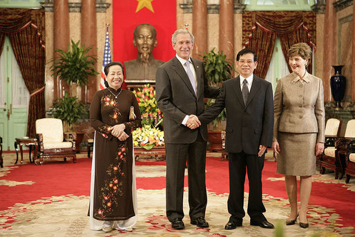 President George W. Bush and Mrs. Laura Bush join Viet President Nguyen Minh Triet and Mrs. Tran Thi Kim Chi in the Great Hall of the Presidential Palace Friday, Nov. 17, 2006, after arriving in Hanoi for the 2006 APEC Summit. White House photo by Eric Draper