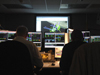 Two engineers in the Space Telescope Operations Control Center sit at consoles during the switch to Side B of the SIC and DH.