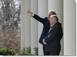 President George W. Bush shows Poland's President Lech Kaczynski points of interest around the White House from the Rose Garden steps outside the Oval Office, Thursday, Feb. 9, 2006 in Washington.  White House photo by Eric Draper