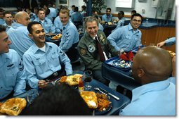 President George W. Bush shares a light moment after lunch with sailors aboard the USS Philippine Sea at Naval Station Mayport in Mayport, Fla., Thursday, Feb. 13, 2003.  White House photo by Eric Draper