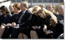 JJoining the family of Space Shuttle Columbia Commander Rick Husband, President George W. Bush and Laura Bush bow their heads in prayer during a memorial service at NASA's Lyndon B. Johnson Space Center Tuesday, Feb. 4, 2003. Sitting with the President are Mr. Husband's wife, Evelyn, and children Laura and Matthew.   White House photo by Paul Morse