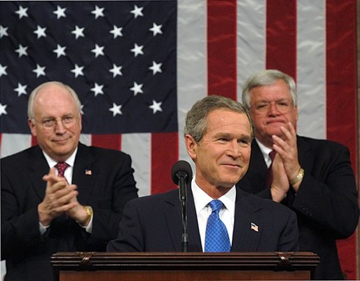 President George W. Bush reacts to applause while delivering the State of the Union address at the U.S. Capitol, Tuesday, Jan. 28, 2003. Also pictured are Vice President Dick Cheney, left, and Speaker of the House Dennis Hastert. White House photo by Eric Draper