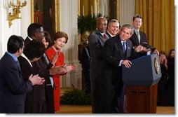 President George W. Bush acknowledges school principals and superintendents, education leaders, and Members of Congress in celebrating the one-year anniversary of the signing of the No Child Left Behind Act in the East Room, Wednesday, Jan. 8, 2003.  White House photo by Tina Hager