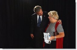 President George W. Bush embraces Loretta De Maintenon after meeting with seniors about his commitment to add prescription drug benefits to Medicare during a visit to Orlando, Fla., Thursday, Nov. 13, 2003.  White House photo by Tina Hager