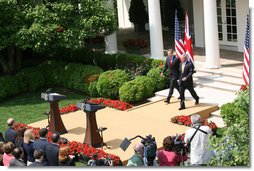 President George W. Bush and Prime Minister Tony Blair of the United Kingdom, walk to the podiums Thursday, May 17, 2007, to begin their joint press availability in the Rose Garden. The visit by Prime Minister Blair marks his last visit in that capacity following his announcement that he'll leave office in June.  White House photo by Shealah Craighead