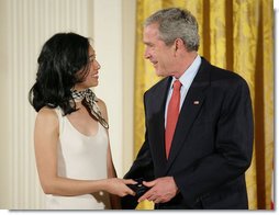 President George W. Bush congratulates Angela An of Washington, D.C., on presenting her the President’s Volunteer Service Award Thursday, May 10, 2007, in the East Room of the White House, in celebration of Asian Pacific American Heritage Month.  White House photo by Eric Draper
