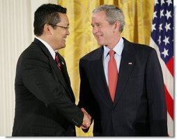 President George W. Bush shakes hands with Kay Hiramine of Colorado Springs, Colo., as he presents Hiramine with the President’s Volunteer Service Award Thursday, May 10, 2007, in the East Room of the White House, in celebration of Asian Pacific American Heritage Month.  White House photo by Eric Draper
