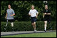 President George W. Bush jogs along the White House jogging track with wounded veterans U.S. Army Sgt. Neil Duncan (Ret.), left, and U.S. Army Specialist Max Ramsey Wednesday, July 25, 2007. White House photo by Chris Greenberg