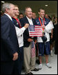President George W. Bush and former President George H.W. Bush pose for photos with U.S. Olympic swimmers Larsen Jensen, left, and Michael Phelps Sunday, Aug. 10, 2008, at the National Aquatics Center in Beijing. White House photo by Shealah Craighead