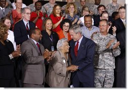 President George W. Bush embraces New Orleans chef and restaurant owner Leah Chase following his address Wednesday, Aug. 20, 2008 at the historic Jackson Barracks in New Orleans, where President Bush honored residents and community leaders for their determination to rebuild their communities three years after Hurricane Katrina devastated the Gulf Coast region. White House photo by Eric Draper