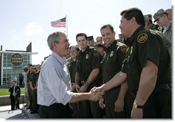 President George W. Bush shakes hands with agents after speaking Monday, April 9, 2007, at the new Yuma Border Patrol Station on comprehensive immigration reform. Speaking in the Arizona border city, the President told his audience, "We've got to resolve the status of millions of illegal immigrants already here in the country. So we're working closely with Republicans and Democrats to find a practical answer that lies between granting automatic citizenship to every illegal immigrant and deporting every illegal immigrant."  White House photo by Eric Draper