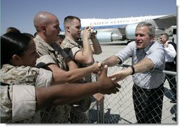 President George W. Bush reaches out to Marines as he prepares to depart the Yuma Marine Corps Air Station in Yuma, Ariz. The stop in the border city was the last before returning to Washington, D. C. after a Easter weekend in Texas.  White House photo by Eric Draper