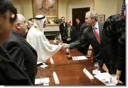 President George W. Bush exchanges handshakes with Mr. Mohammed Jaber during a visit at the White House Wednesday, Jan. 18, 2006, with victims of Saddam Hussein. Mr. Jaber is a former Iraqi journalist who was jailed for writing a story that raised questions about how oil money was being spent.  White House photo by Eric Draper