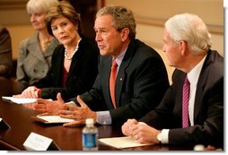 President George W. Bush, with Mrs. Bush, speaks to the press during a meeting with foundations to help aid Gulf coast Recovery at the White House, Thursday, Jan. 19, 2006.  White House photo by Eric Draper