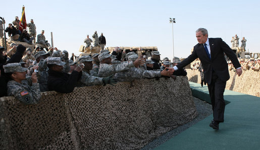 President George W. Bush reaches out to troops at Camp Arifjan in Kuwait Saturday, Jan. 12, 2008, during his last stop in the country before continuing on to Bahrain. White House photo by Eric Draper