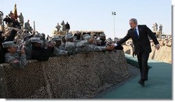 President George W. Bush reaches out to troops at Camp Arifjan in Kuwait Saturday, Jan. 12, 2008, during his last stop in the country before continuing on to Bahrain. White House photo by Eric Draper