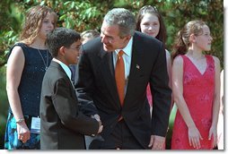 President George W. Bush greets one of the award winners during the 2002 President's Environmental Youth Awards Ceremony in The Rose Garden April 18. "I want to thank so much the award winners for turning idealism into action; for taking a great spirit and love for our country and doing something about that spirit and love for our country." White House photo by Paul Morse.
