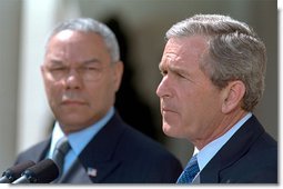 President George W. Bush outlines his plan to resolve the conflict in the Middle East as Secretary of State Colin Powell stands by his side in the Rose Garden Thursday, April 4. White House photo by Paul Morse.