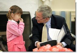 President George W. Bush spends a few moments with Kim Han-Mee in the Oval Office, the daughter of North Korean defectors, during a meeting April 28, 2006 with North Korean defectors and family members of Japanese citizens who were abducted by North Korea.  White House photo by Paul Morse