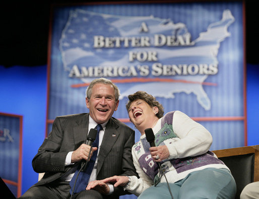 President George W. Bush shares a laugh with panel participant Helen Robinette during a conversation about Medicare prescription drug benefits at the Etta & Joseph Miller Performing Arts Center in Jefferson City, Mo., Tuesday, April 11, 2006. White House photo by Eric Draper