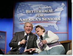 President George W. Bush shares a laugh with panel participant Helen Robinette during a conversation about Medicare prescription drug benefits at the Etta & Joseph Miller Performing Arts Center in Jefferson City, Mo., Tuesday, April 11, 2006.  White House photo by Eric Draper
