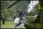 Before attending a meeting with administration officials, Sikh religious and community leaders watch as President George W. Bush departs the White House aboard Marine One Wednesday, Aug. 18, 2004.