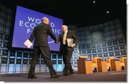Vice President Dick Cheney greets professor Klaus Schwab, founder and president of the World Economic Forum, before addressing more than 1,000 attendees at World Economic Forum in Davos, Switzerland Jan. 24, 2004. During his speech, Vice President Cheney said international cooperation is required to win the war on terror. "We must meet the dangers together. Cooperation among our governments, and effective international institutions, are even more important today than they have been in the past."  White House photo by David Bohrer