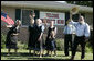 An excited group of Amish and Mennonite residents wave to President George W. Bush Wednesday, Aug. 16, 2006 in Lancaster, Pa., upon his arrival aboard Marine One. White House photo by Kimberlee Hewitt